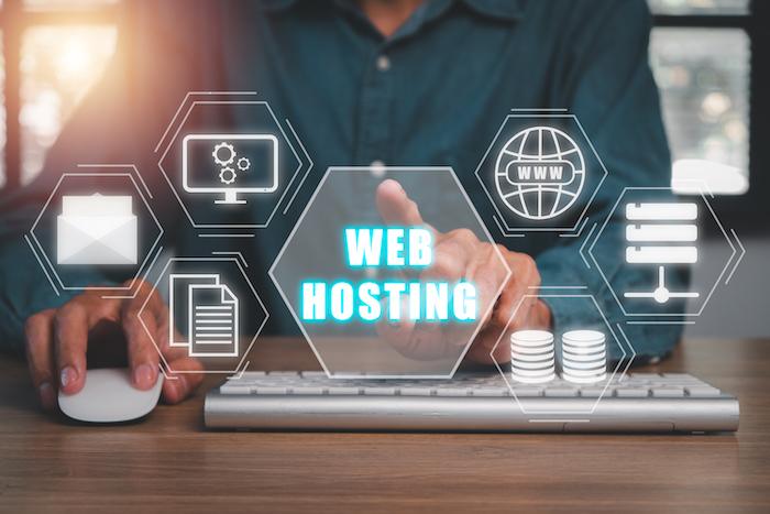 5 Reasons Why Serious Bloggers Need to Invest in Web Hosting. Web hosting concept, Person using computer and presses his finger on the virtual screen inscription Hosting on desk, Internet, business, Technology and network concept.